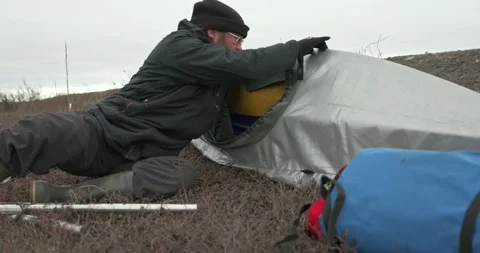 Man in glasses assembles kayak putting reinforcing elements Stock Footage 197059883