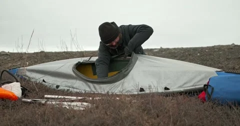 Man in glasses assembles kayak putting reinforcing elements Stock Footage 197059890