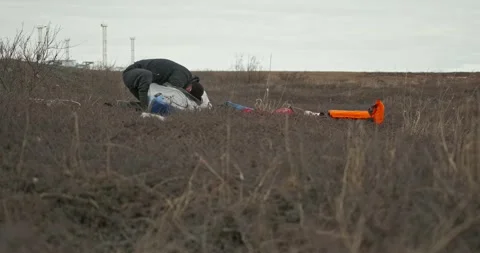 Man in glasses assembles kayak putting reinforcing elements Stock Footage 197059936