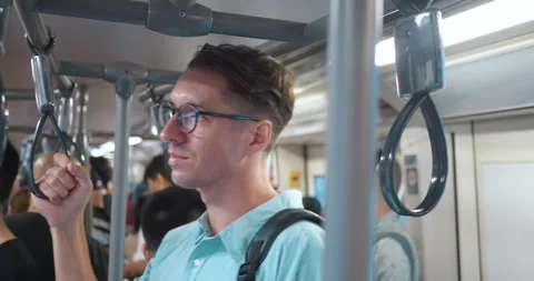 Man glasses, backpack back, grips handrail subway, vivid portrayal everyday Stock Footage 270417048