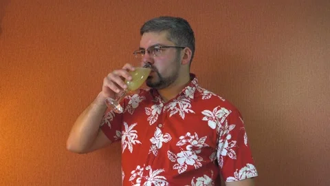 A man in glasses with a beard drinks juice Vídeo Stock 196168703