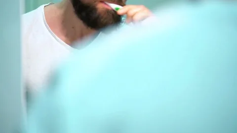 Man in glasses brushing his teeth in the morning Stock Footage 73477988