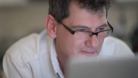 Man in glasses at computer smiling Stock Footage 201501684
