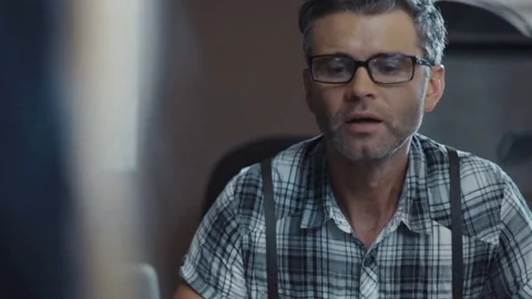 The man in the glasses is delighted to look into the book. Interior designer Stock Footage