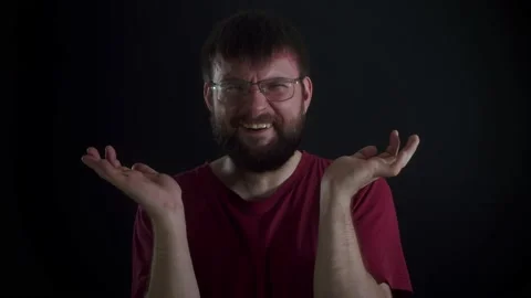 A man with glasses does not understand anything and throws up his hands Stock Footage 169667562