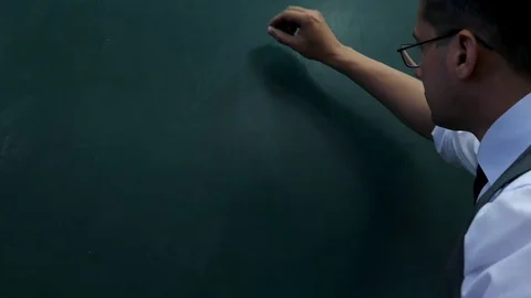 The man in the glasses draws items of his plan on the blackboard. Stock Footage 90371550