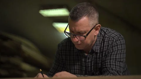 Man with glasses at the factory checks technical documentation of the project Stock Footage 149313111