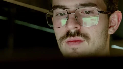 Man with glasses focused on screen reflection Stock Footage 342779856