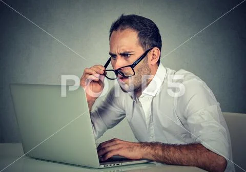 Man with glasses having eyesight problems confused with laptop software Stock Photos