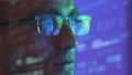 The man in glasses looking to the display on the hologram background 4k or 4k+ Resolution