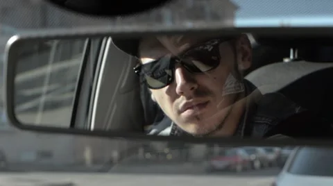 The man in glasses looking in the rearview mirror. Stock Footage 51756698