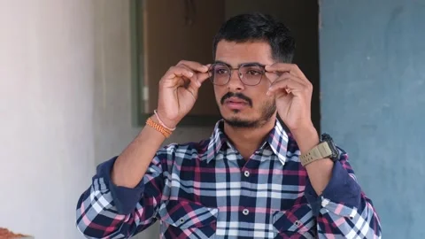 Man with glasses looking surprised and happy with improved clear vision 스톡 동영상 329921924