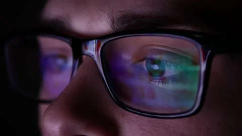 Man in glasses at night looking for a solution on the Internet. Working at night Stock Footage 134566282
