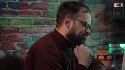 Man With Glasses Playing With Pencil in Front of Desktop Computer From 1980's Stock Footage 305818372