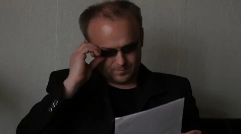 Man in glasses read documents, tearing them and throws away Stock Footage 48650418