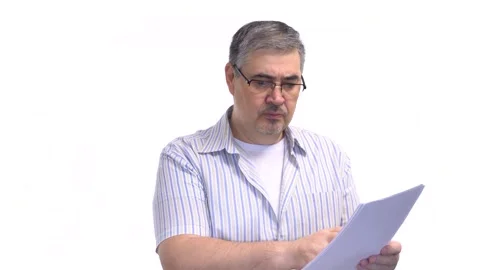 Man in Glasses Reading Papers and Nodding Head. White Background. Stock Footage 276612134