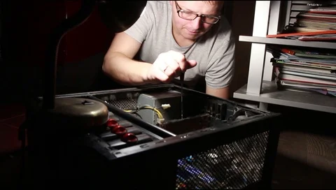 A man in glasses repairs a computer system unit Stock Footage 112520096