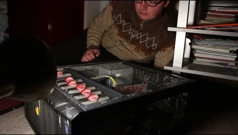 A man in glasses repairs a computer system unit Stock Footage 112520127