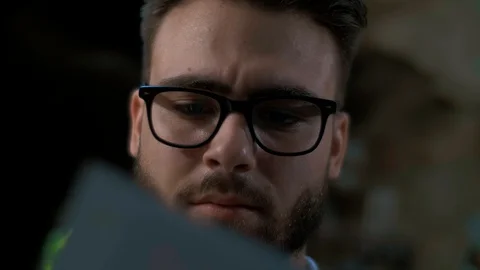 A man in glasses for sight studies the documentation, close-up Stock Footage 128744413