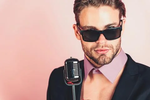 Man in glasses sing in microphone. Stock Photos