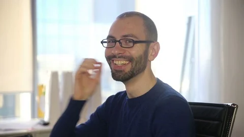 The man in glasses smiles and laughs Stock Footage 69986561