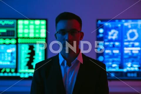 The man in glasses standing on screens background Stock Photos
