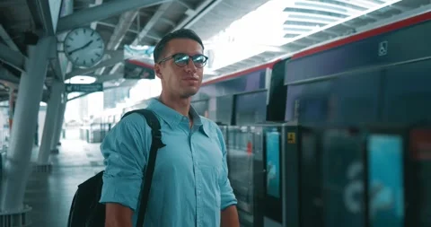 Man glasses stands station while train passes by. moment captured he stands Stock Footage 263178696