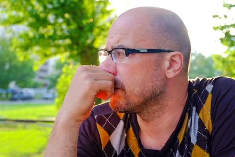 The man with glasses suffers from depression . Problems in personal life and at Stock Photos
