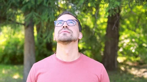 A man in glasses takes a deep breath of fresh air Stock Footage 247125023