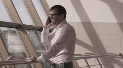 Man with glasses talking on the phone 動画素材 55495617