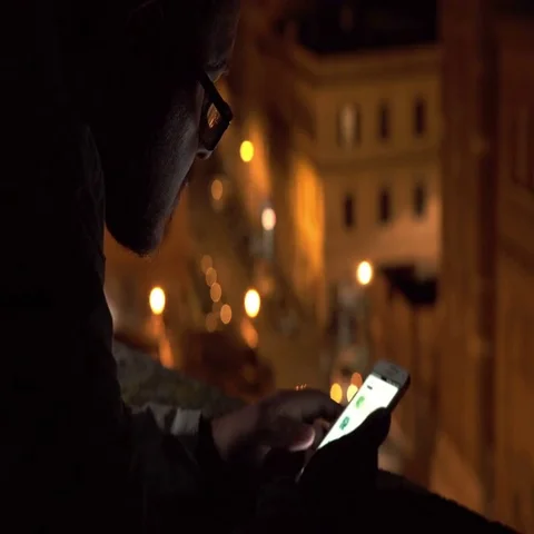  man with glasses in twilight on the terrace using his smartphone Stock-Footage 69521419