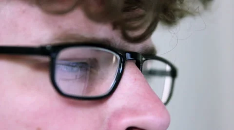 A man with glasses is using a computer Stock Footage 40184349