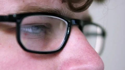 A man with glasses is using a computer Stock Footage 40184811