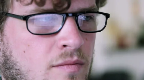 A man with glasses is using a computer Stock Footage 40185178