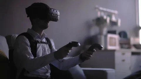 Man in glasses of virtual reality slowly moves his hands at home Video stock 117537052