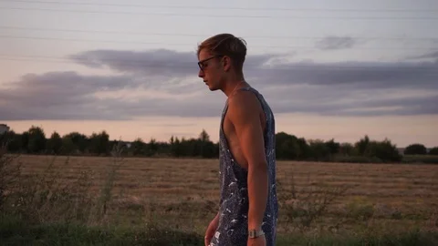 Man in glasses walking at sunset Stock Footage 114631411