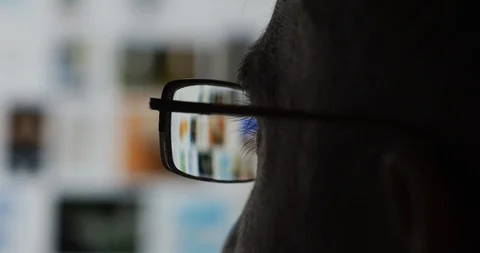 Man with glasses watching a screen Stock Footage 99745553