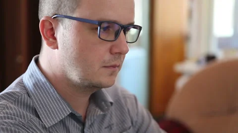 Man with glasses working at the computer and t tired eyes Stock Footage 64831233
