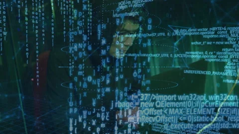 Man with glasses working at dark tech workstation, interfacing with holographic 库存影片 309105824