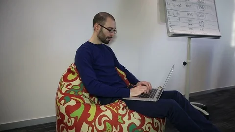 Man with glasses working on laptop Video stock 69986547