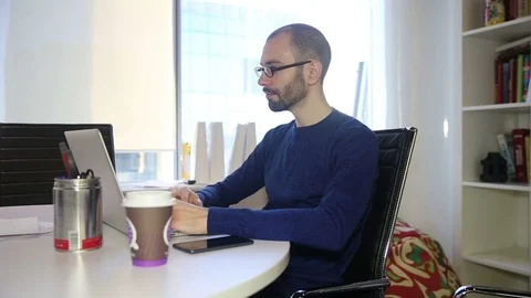 The man in glasses working laptop Stock Footage 69986678