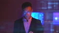 The man in glasses working with a tablet on the hologram background 4k or 4k+ Resolution