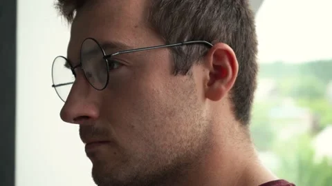 Man in glasses works at the computer and smiles Stock Footage 167133499