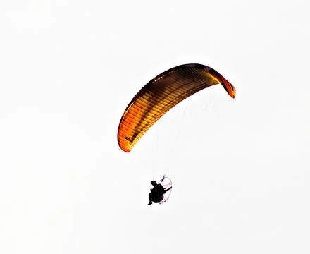 Man gliding over the coastline Stock Photos