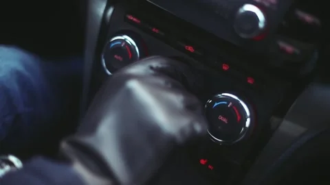 A man in gloves adjusts the temperature in the car Stock Footage 170555615