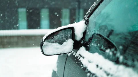 Man in gloves brushing deep snow from car windshield wiper blades Stock Footage 341950665