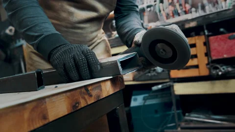 A man in gloves cuts metal with a circular saw, a lot of sparks. The working Stock Footage 142190868