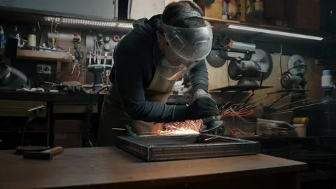 A man in gloves cuts metal with a circular saw, a lot of sparks. The working Stock Footage 142252015