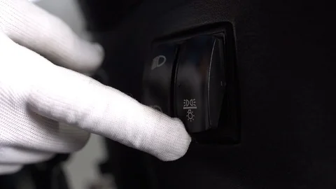 A man in gloves presses the low and high beam button on the tractor Stock Footage 128678661