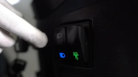 A man in gloves presses the low and high beam button on the tractor Stock Footage 128678730